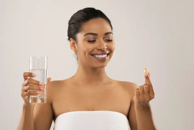happy woman holding vitamins