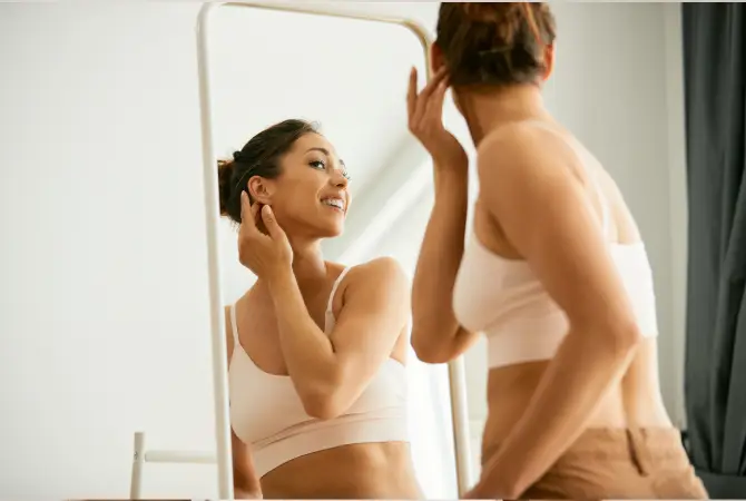 woman happily looking at her reflection